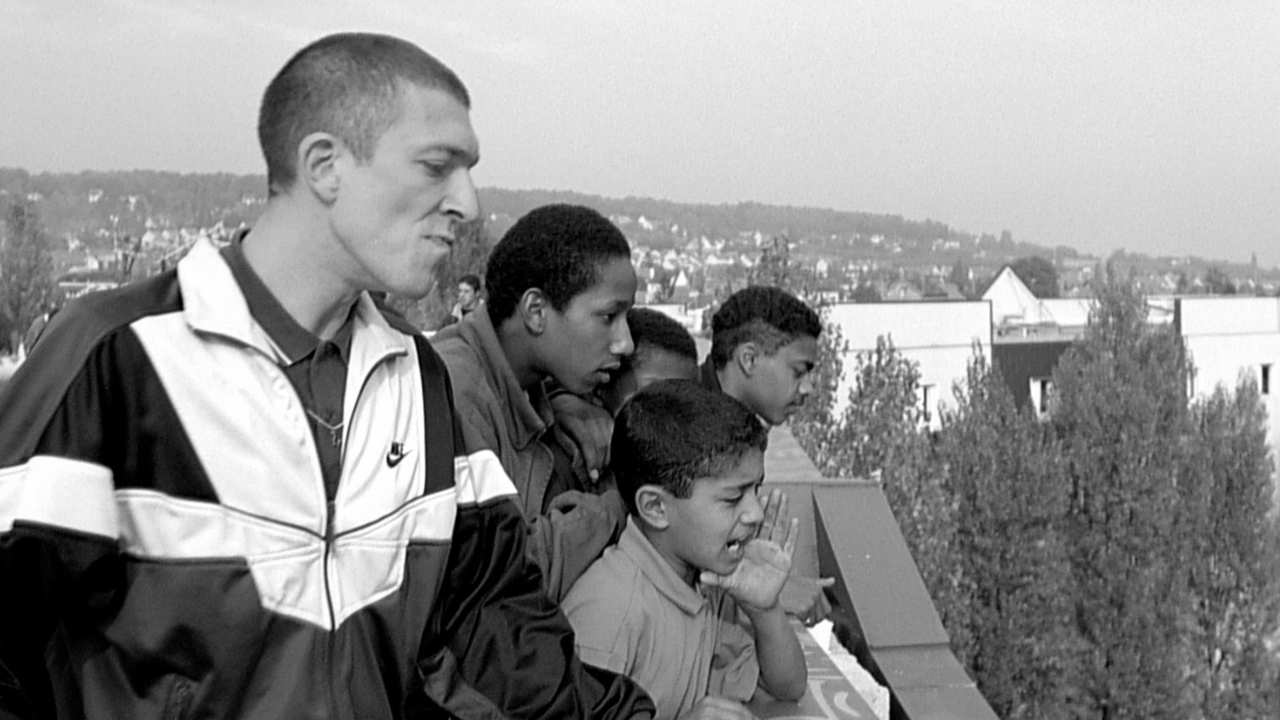 a group of young men looking down from a roof